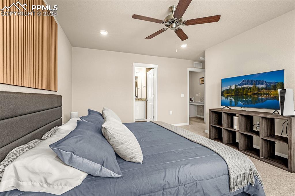 Image 12 of 35: Bedroom featuring carpet, ensuite bathroom, recessed lighting, ceiling fan,