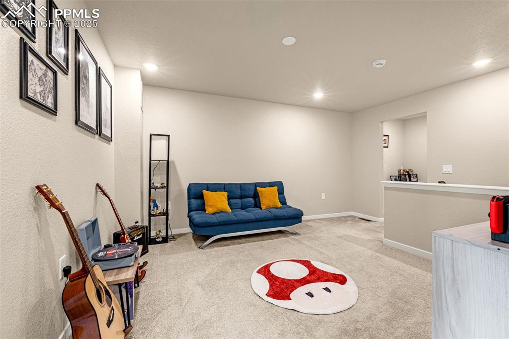 Image 24 of 35: Sitting room featuring light carpet and recessed lighting