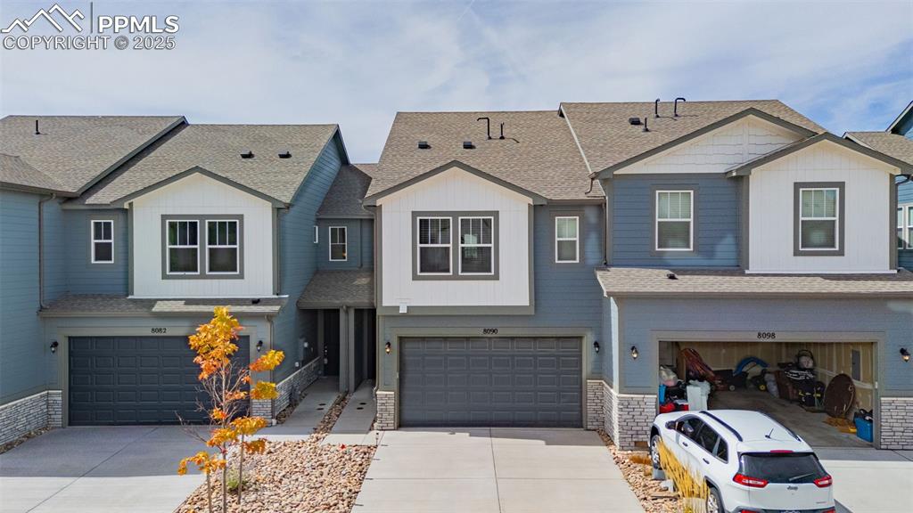 Image 29 of 35: View of front of property with a shingled roof and concrete driveway