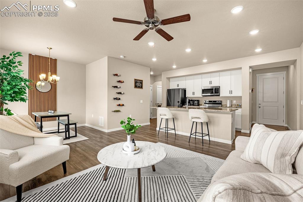 Image 3 of 35: Living room with recessed lighting, dark wood finished floors, and a ceilin