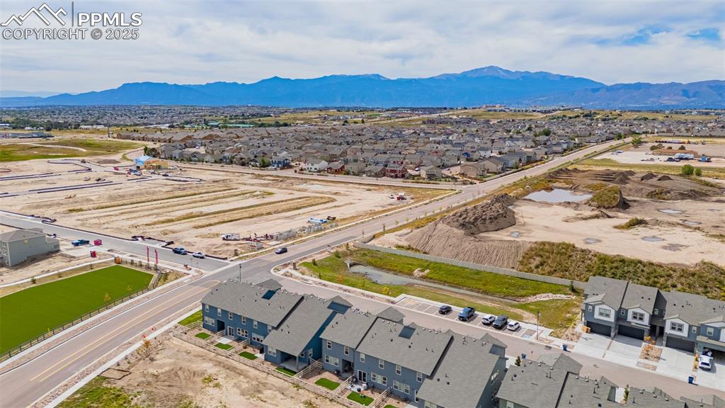 Image 35 of 35: Aerial view of residential area featuring a mountain backdrop