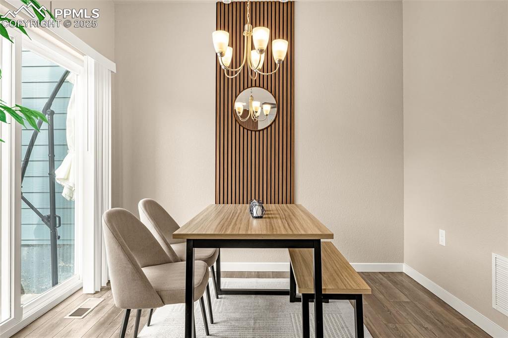 Image 5 of 35: Dining room with a chandelier and wood finished floors