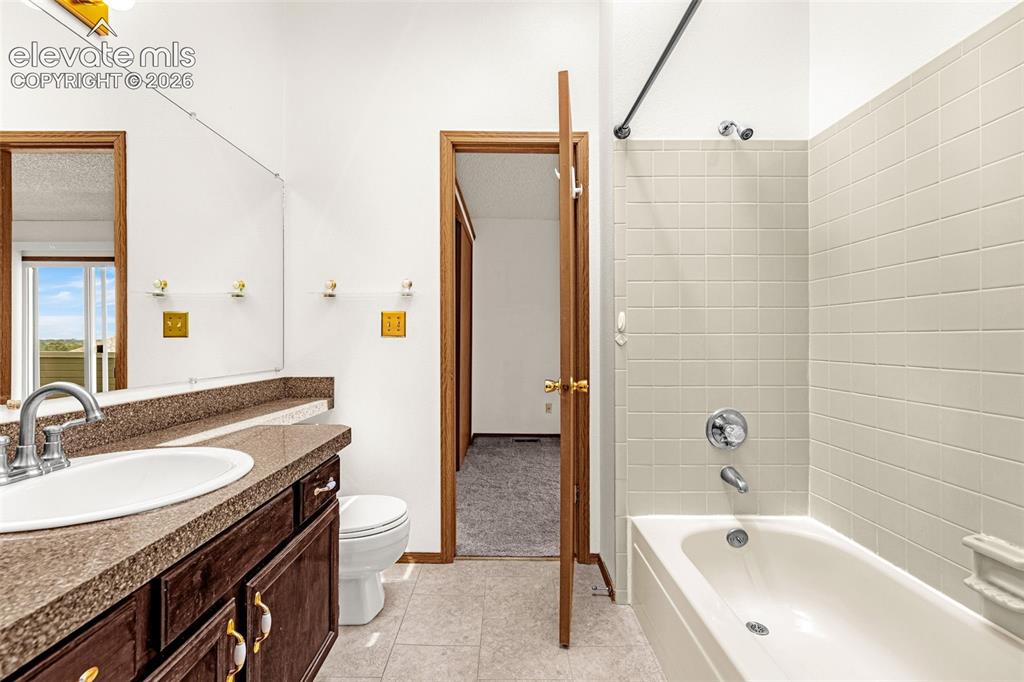 Image 14 of 32: Bathroom featuring a single vanity with a dark wood-finish cabinet, integra