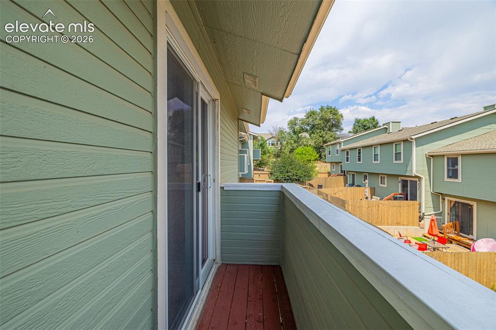 Image 20 of 32: Private balcony featuring wood-finish flooring and a sliding glass door