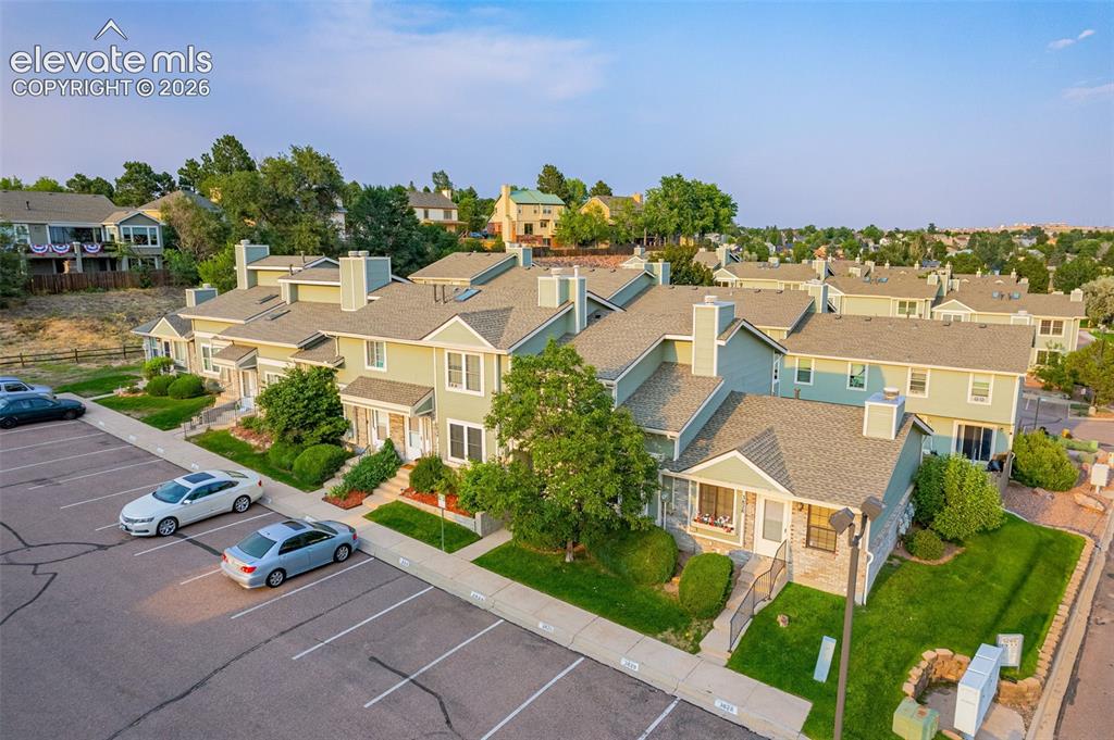 Image 23 of 32: Residential complex featuring multiple units, ample surface parking, indivi