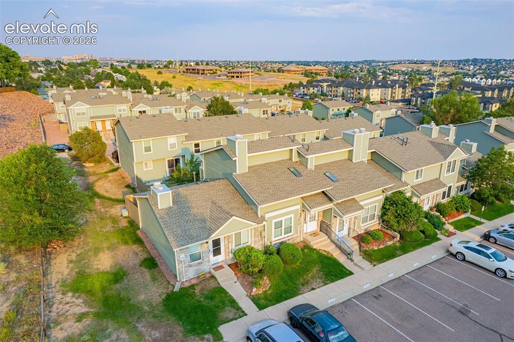 Image 24 of 32: Townhome community featuring pitched roofs, multiple chimneys, and a dedica