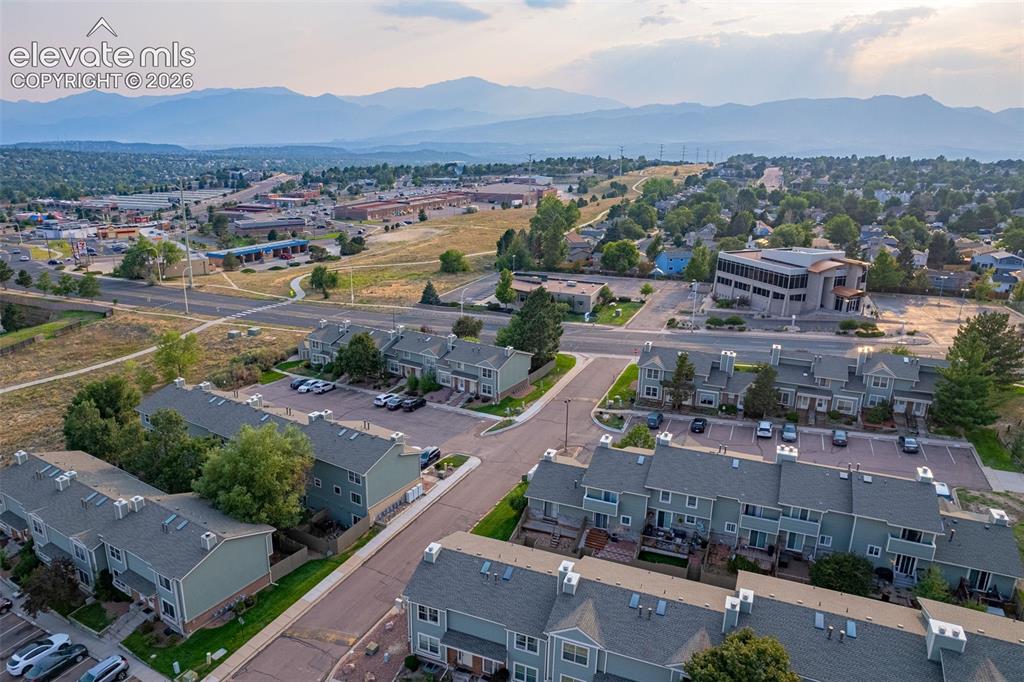 Image 26 of 32: Residential community with a mountain backdrop, multiple asphalt parking ar