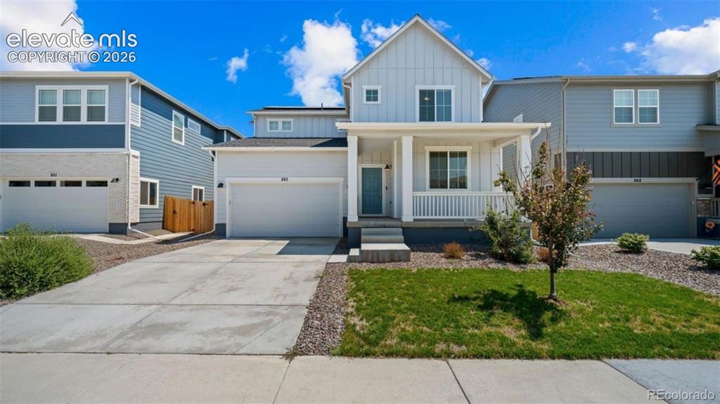 Caption: Contemporary two-story exterior with light gray siding and white trim