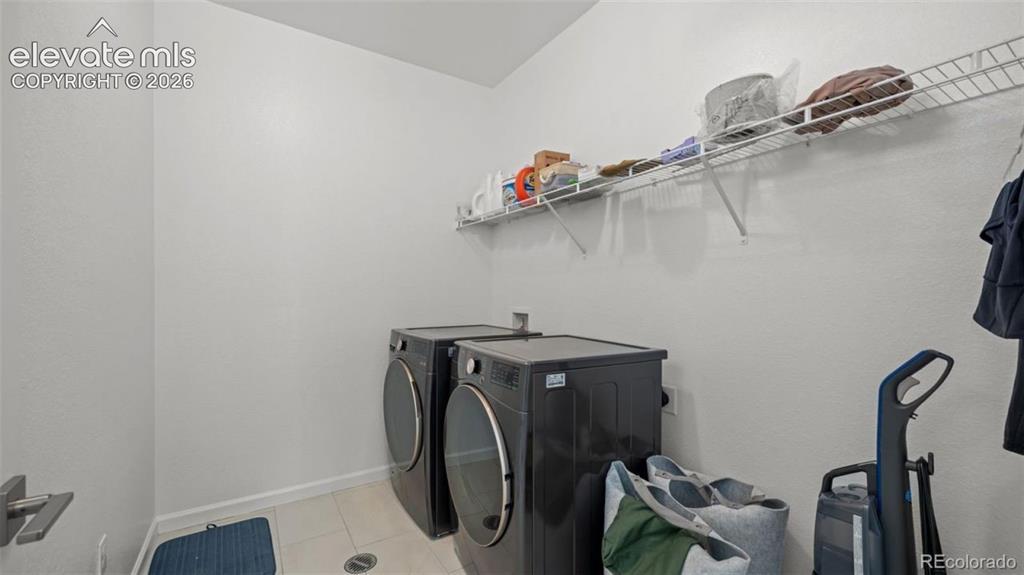 Image 25 of 38: Dedicated utility space featuring a wire storage shelf and tile flooring