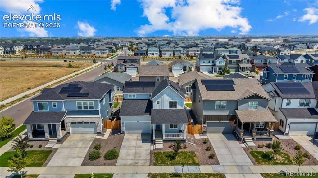 Image 28 of 38: Residential street with varied architectural styles, private driveways, and