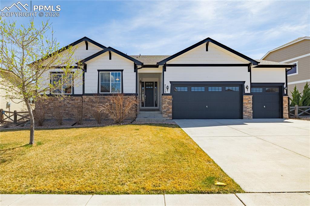 Image 1 of 37: Craftsman house featuring a garage, driveway, and stone siding