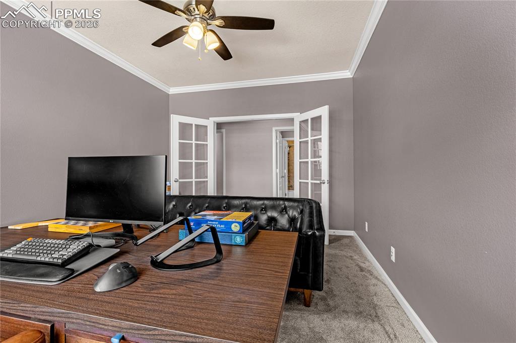 Image 21 of 37: Office space with crown molding, carpet flooring, and ceiling fan