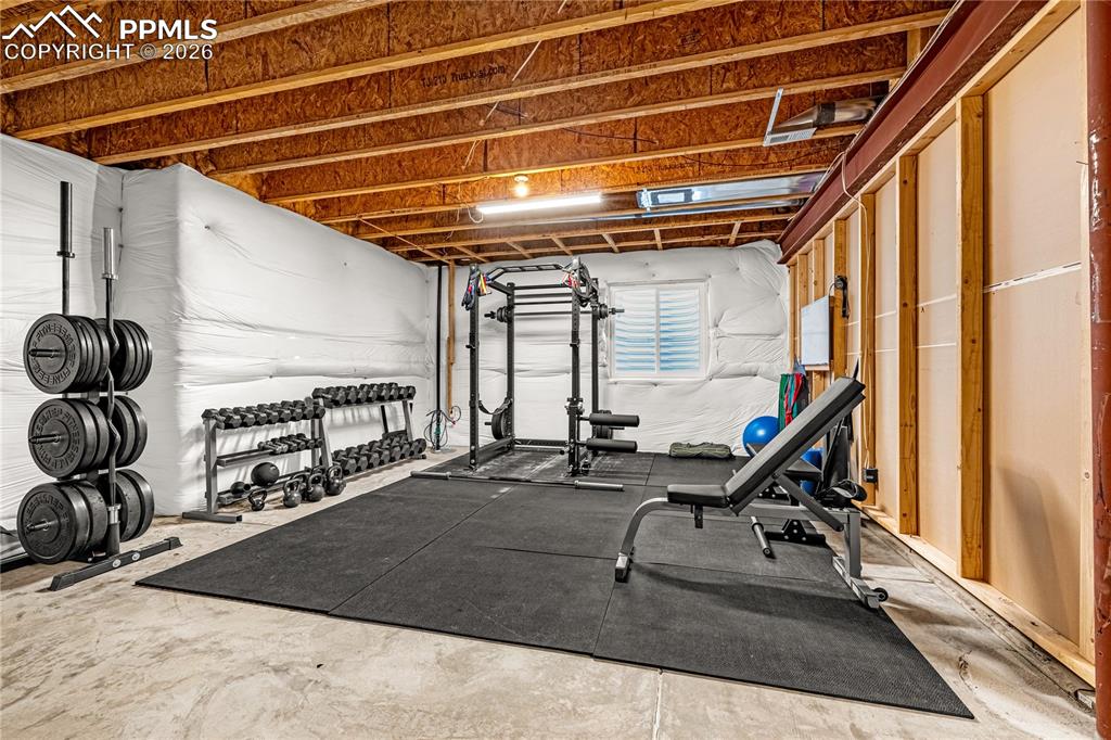 Image 25 of 37: Workout area with concrete flooring