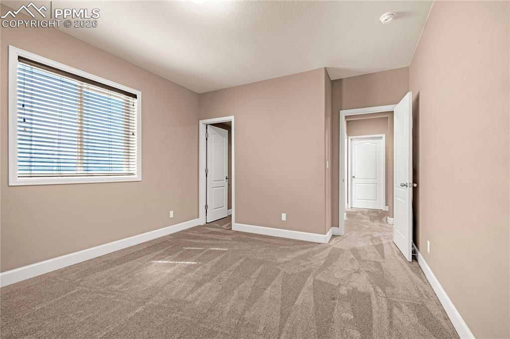 Image 28 of 37: Unfurnished bedroom featuring light colored carpet and baseboards