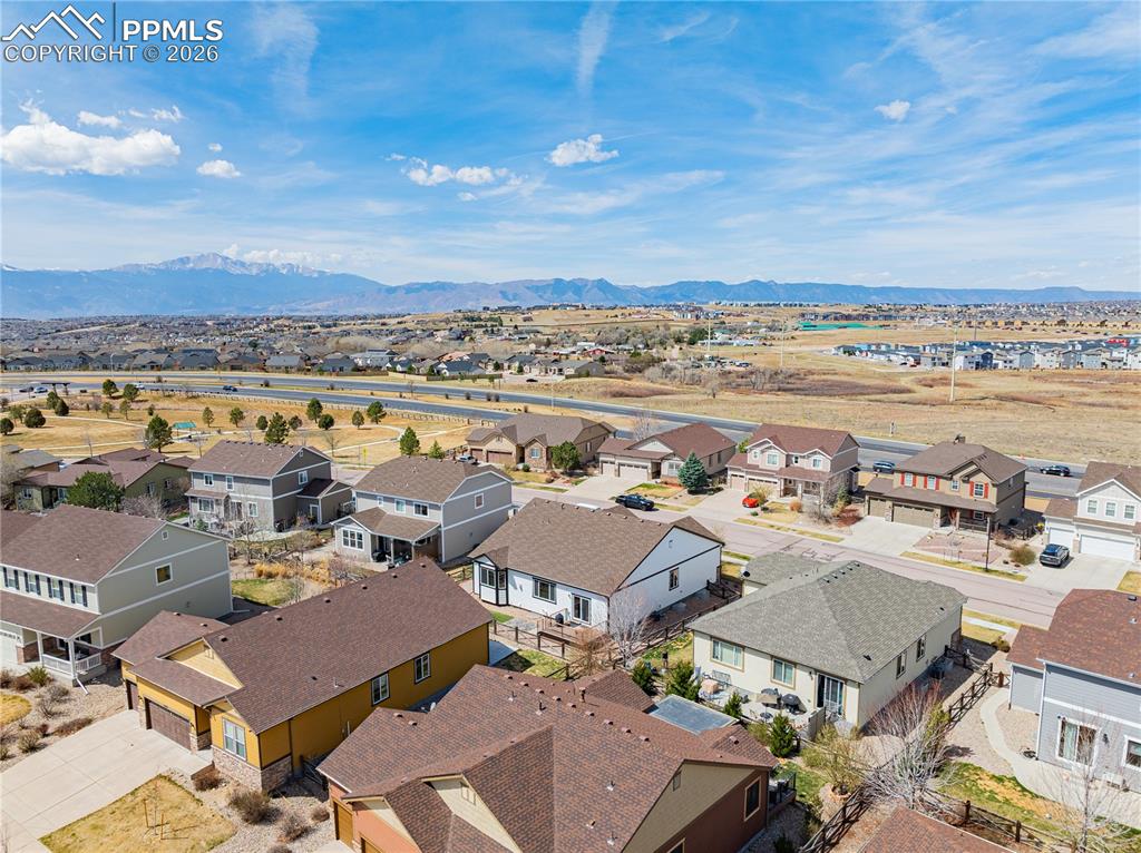 Image 4 of 37: Aerial view of residential area featuring a mountain backdrop