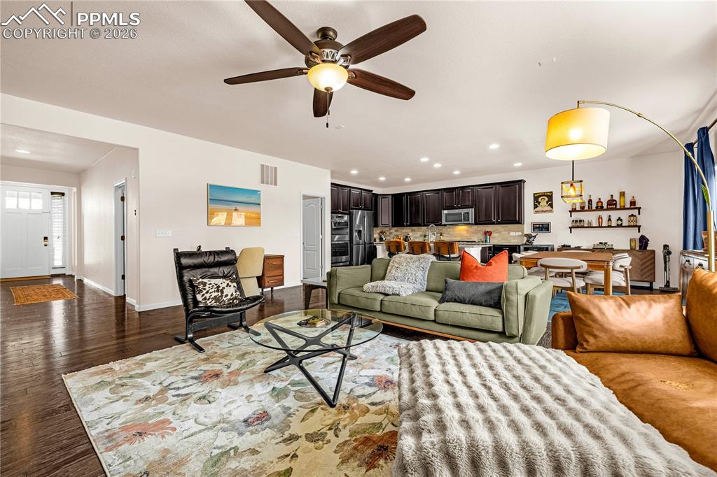 Image 7 of 37: Living room with recessed lighting, wood finished floors, and a ceiling fan