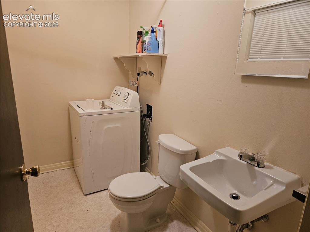Image 29 of 44: 1/2 Bath, out of the Bonus Room.  Clothes washer setup in this bathroom.