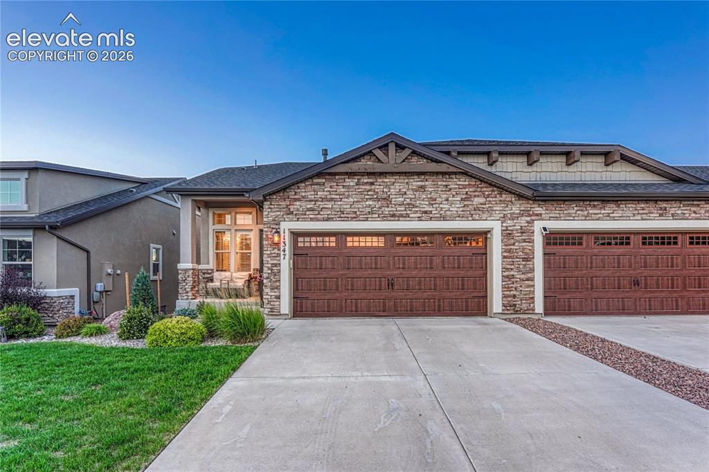 Image 1 of 47: Beautifully maintained Challenger patio home showcasing a timeless stone an