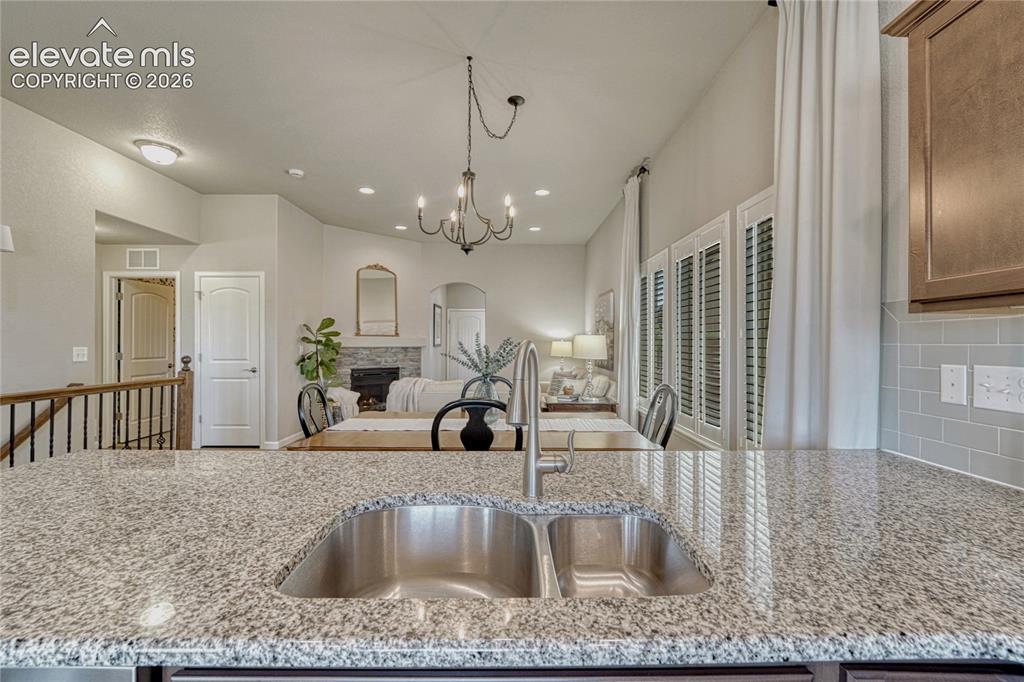 Image 11 of 47: The kitchen opens seamlessly to the dining and living room areas, creating
