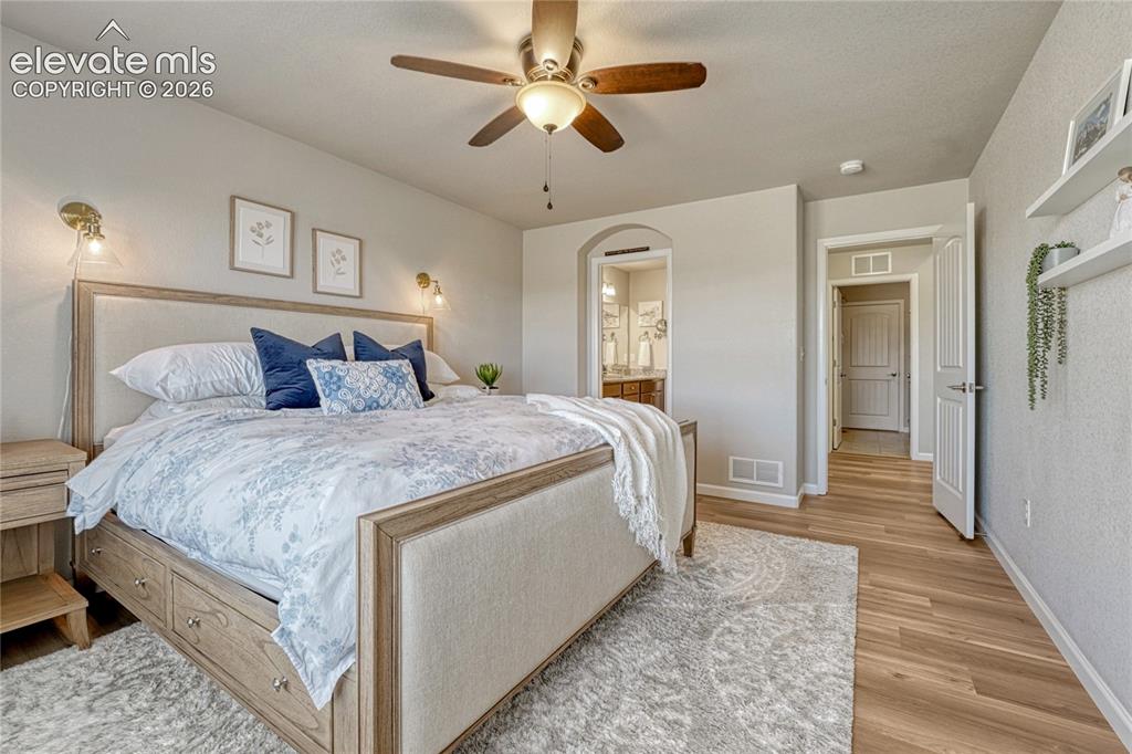Image 17 of 47: The main-level primary suite offers comfort and convenience with spacious p