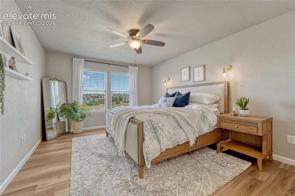 Image 18 of 47: Wake up to natural light and peaceful views in this spacious primary bedroo