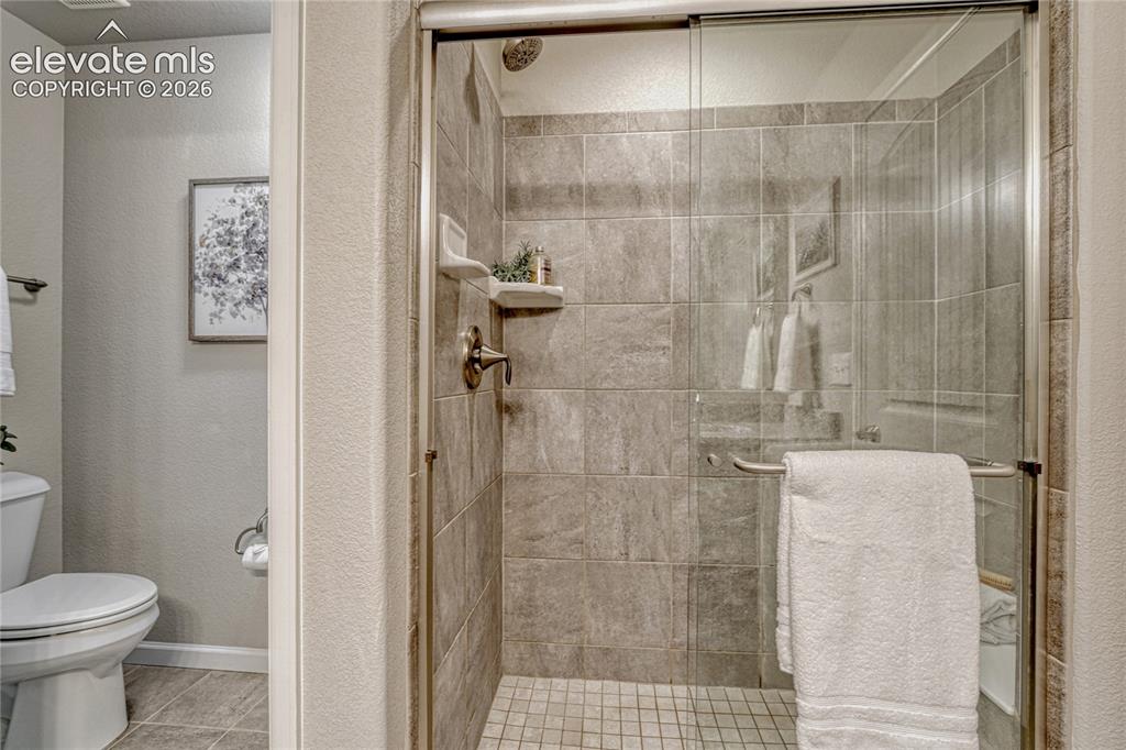 Image 21 of 47: A beautifully finished walk-in shower provides a modern touch with tiled wa