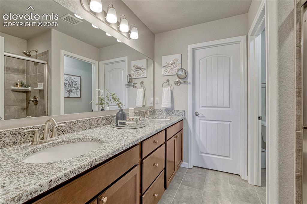 Image 22 of 47: Convenient access from the primary bathroom leads to a spacious walk-in clo
