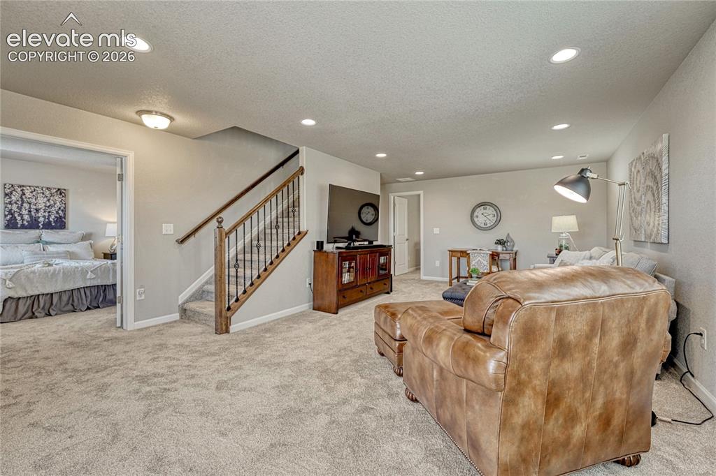 Image 26 of 47: A flexible basement living area provides additional space for hobbies, movi