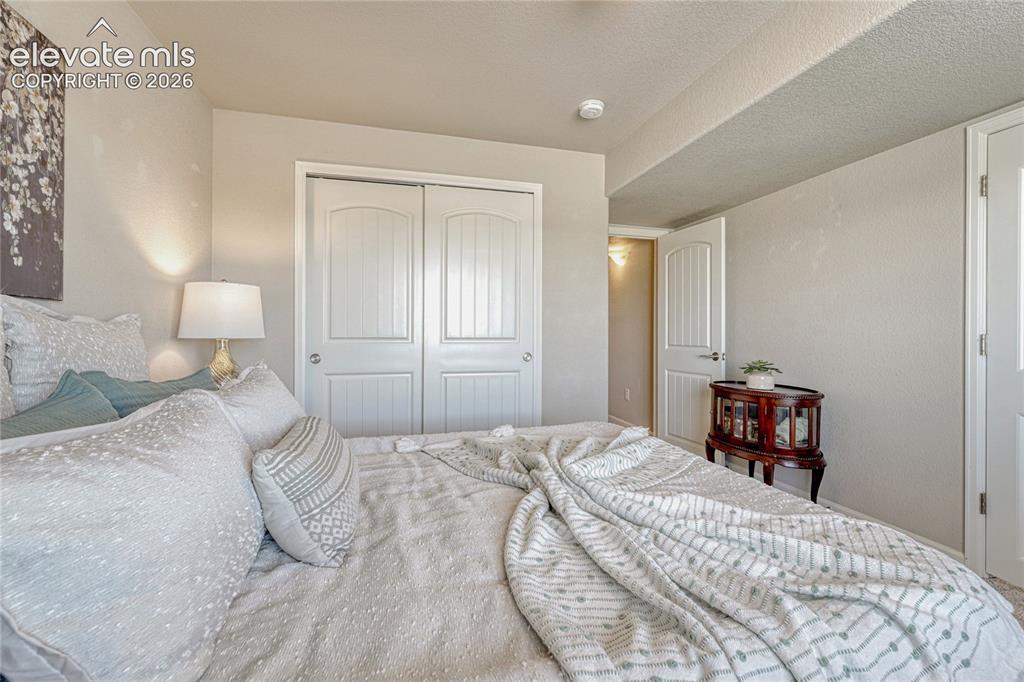 Image 28 of 47: The basement bedroom provides an ideal space for family members, guests, or