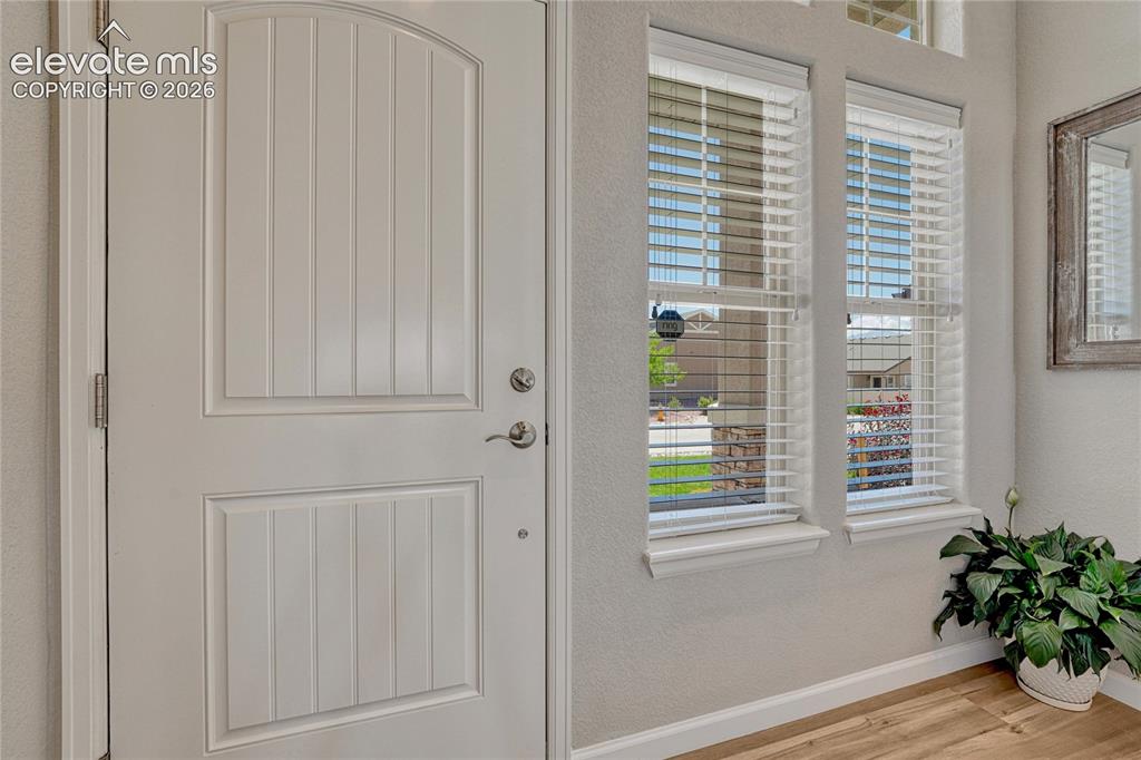 Image 3 of 47: Step inside to a bright entryway with warm luxury vinyl flooring and an inv