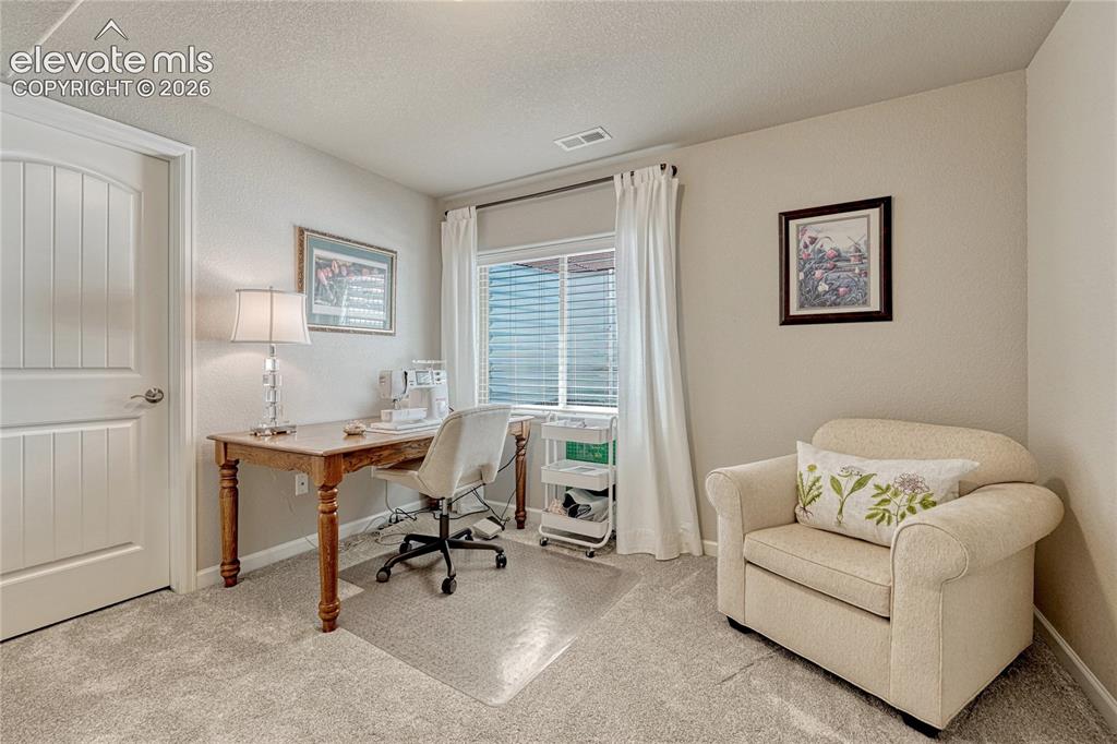 Image 31 of 47: A bright second basement bedroom offers flexibility with natural light, com