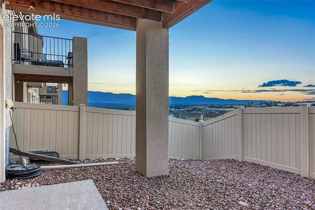 Image 38 of 47: Relax outdoors while taking in sweeping mountain and sunset views from the