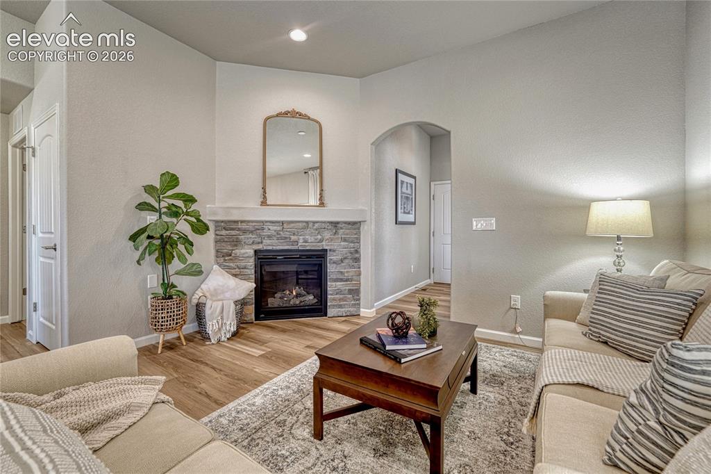 Image 4 of 47: Relax and unwind in the living room, where a corner stone gas-log fireplace
