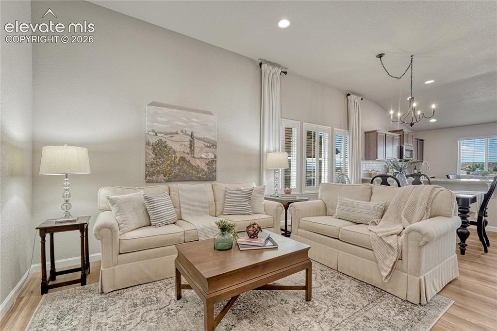 Image 6 of 47: Vaulted ceilings and abundant natural light enhance the open-concept living