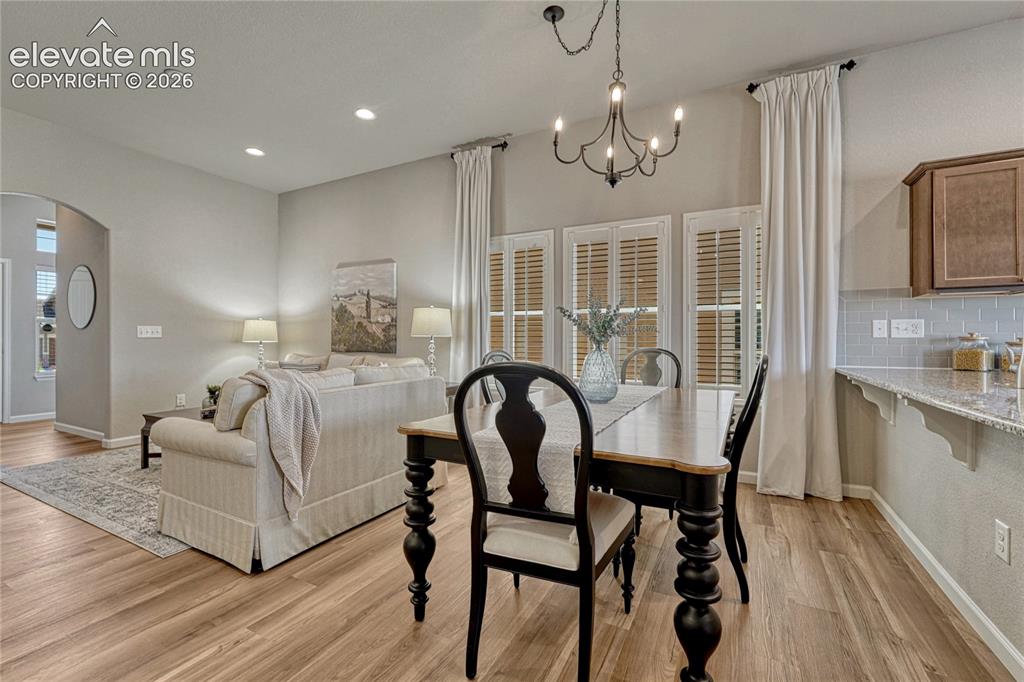 Image 8 of 47: The dining space sits between the living room and kitchen breakfast bar.