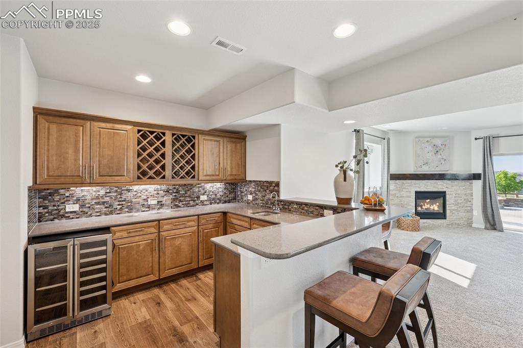 Image 45 of 50: Wet bar in walkout basement