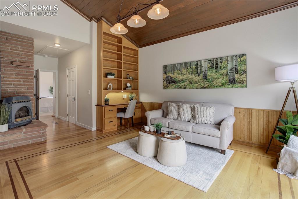 Image 17 of 33: Loft w/ shelving & fireplace