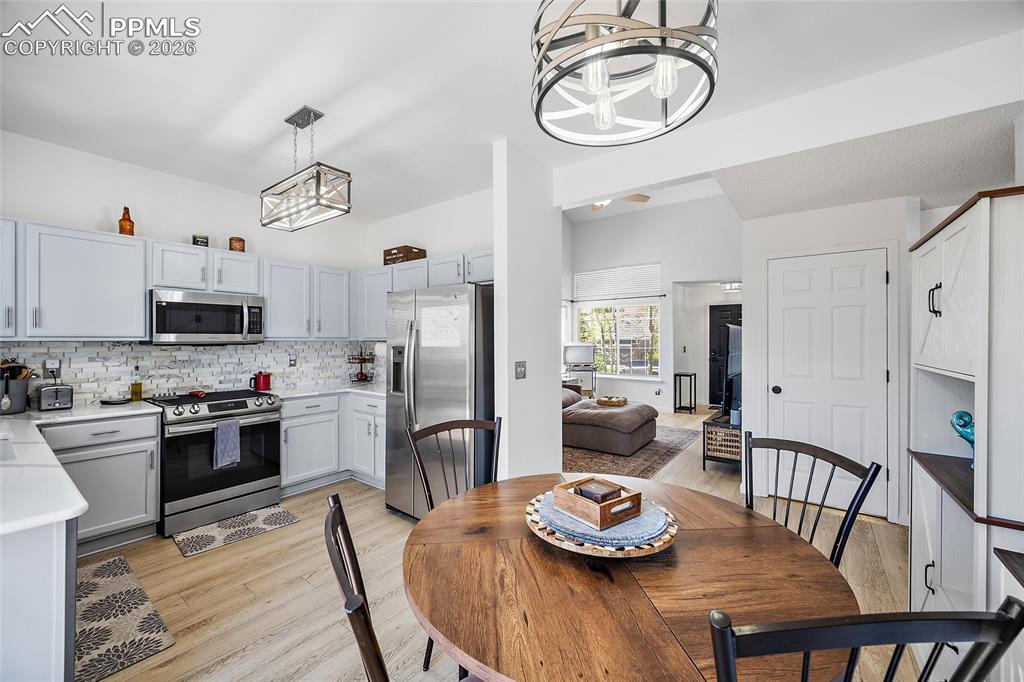 Image 10 of 46: Kitchen featuring light gray cabinetry, stainless steel appliances, and a m