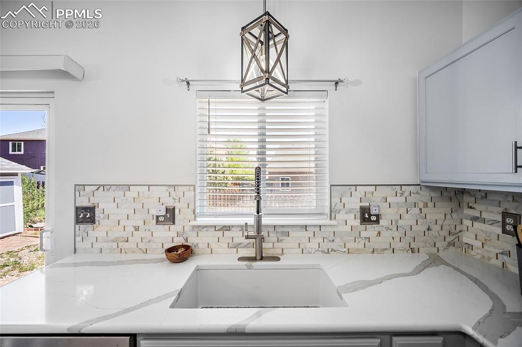Image 13 of 46: Kitchen featuring a white single-basin sink with a gooseneck faucet, quartz