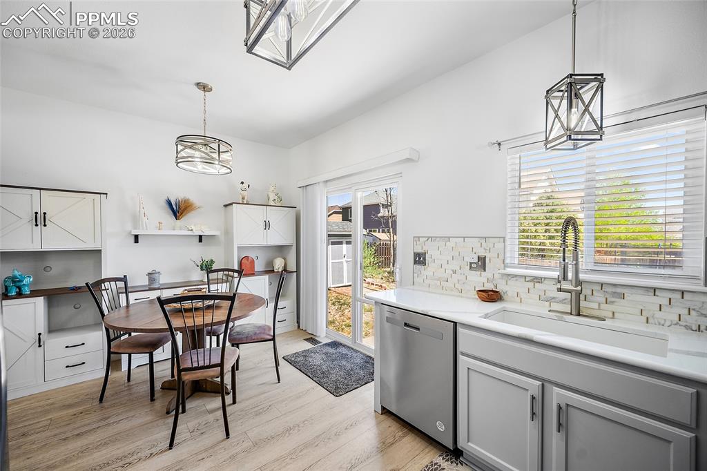 Image 14 of 46: Kitchen area featuring light wood-finish flooring and white walls