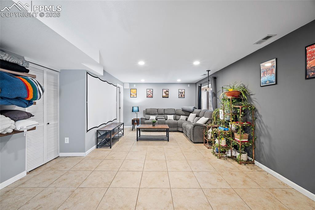 Image 28 of 46: Spacious recreational room featuring tile flooring, recessed lighting, and 