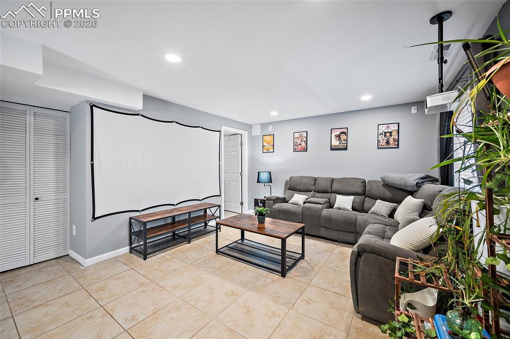 Image 29 of 46: Recreation room featuring recessed lighting, tile flooring, a mounted proje