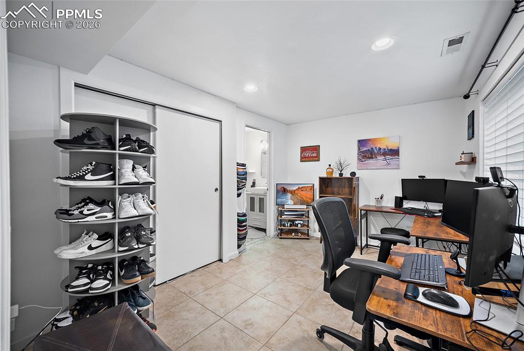 Image 31 of 46: Recessed lighting illuminates this versatile room featuring tiled flooring,