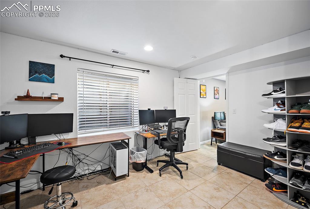 Image 32 of 46: Versatile interior space featuring light-toned tile flooring, recessed ceil
