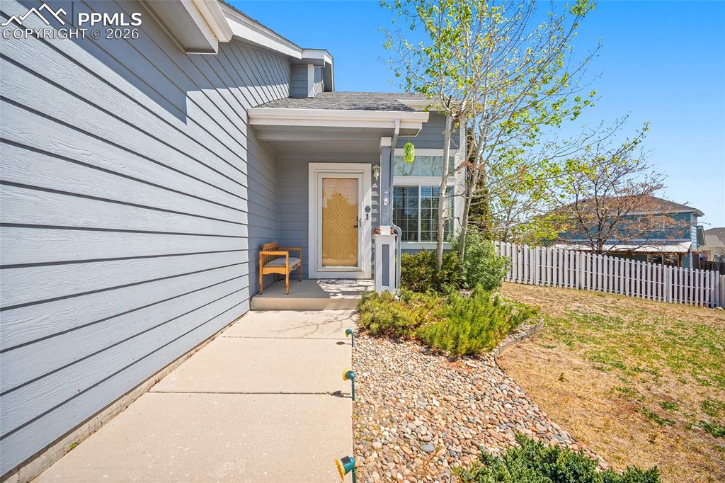 Image 4 of 46: Front entryway featuring light blue siding and a covered porch