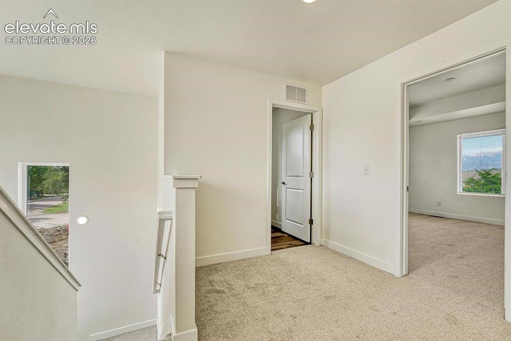 Image 17 of 50: Primary bedroom suite, two bedrooms, full Jack-and-Jill bath, and laundry a