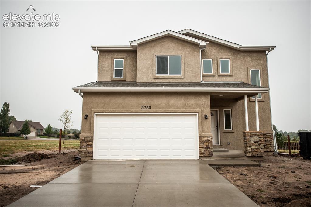 Image 2 of 29: Stucco and stone exterior