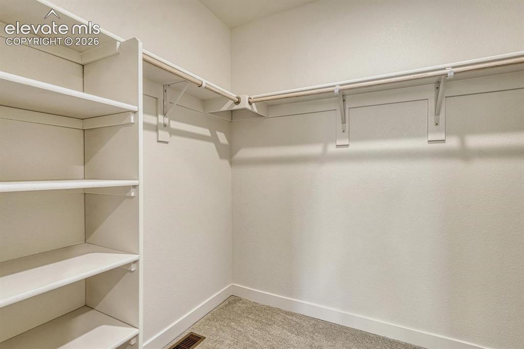 Image 26 of 50: Large walk-in closet is through the primary bathroom
