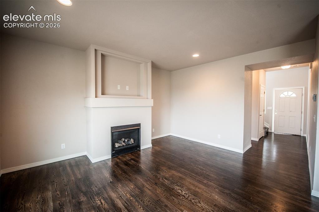 Image 3 of 29: Living room featuring gas fireplace and LVP flooring