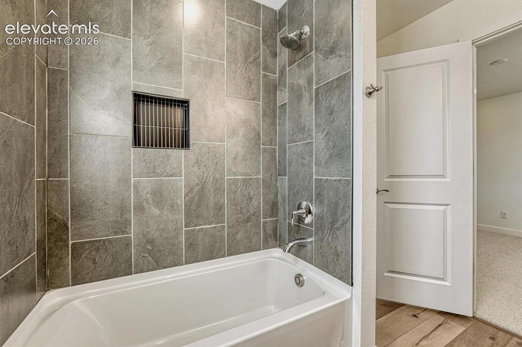 Image 31 of 50: Shower tub with tile surround